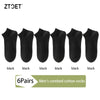 Six pairs of black men's combed cotton socks laid out in a row.