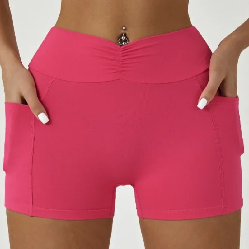 A model is wearing bright pink high-waisted yoga and fitness leggings.