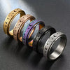 A row of stainless steel spinning rings featuring moon and star designs in gold, rose gold, and black finishes.