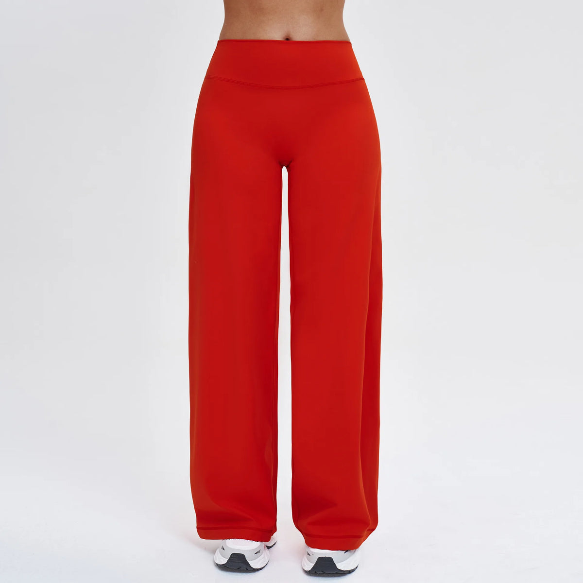 A full-length shot of a red high-waist wide-leg yoga legging worn by a person.