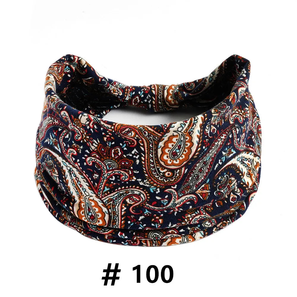 A dark blue and brown boho print cotton headband for hair and workout.