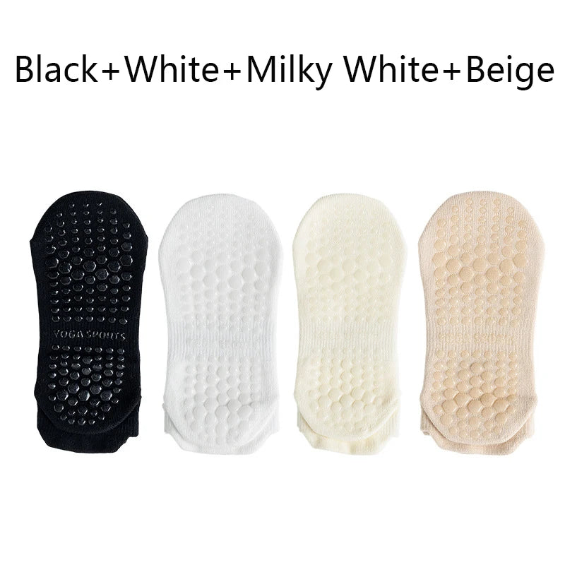 A pack of four non-slip yoga socks in black, white, milky white, and beige colors.
