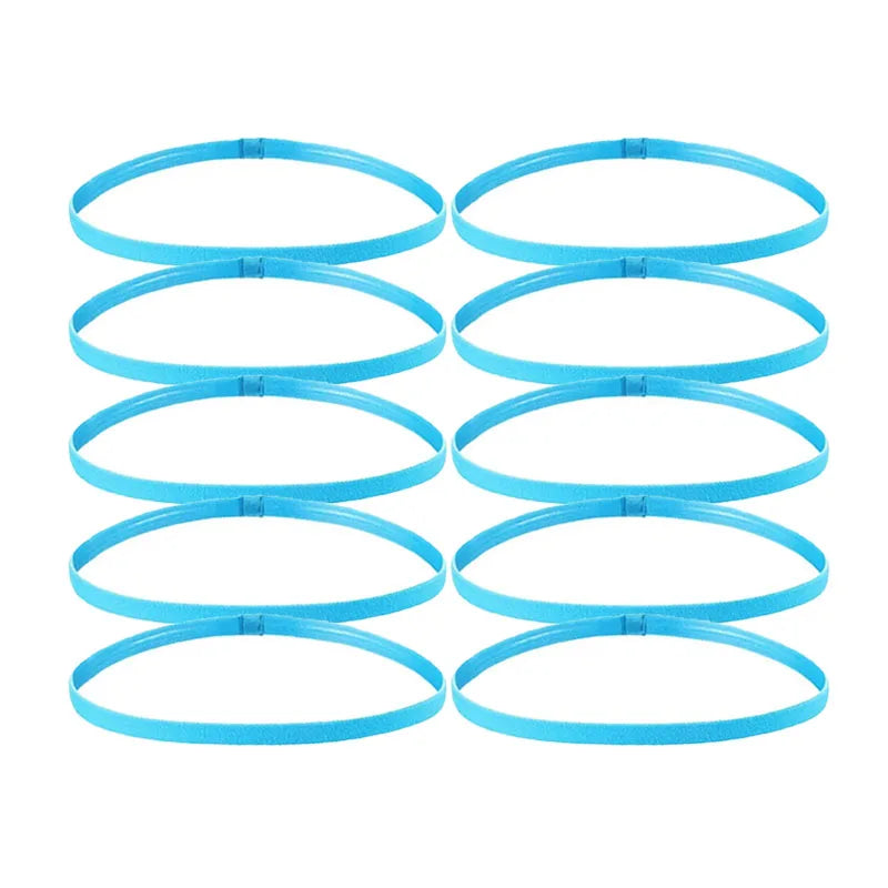 A set of five bright blue elastic sports headbands laid out in a row.
