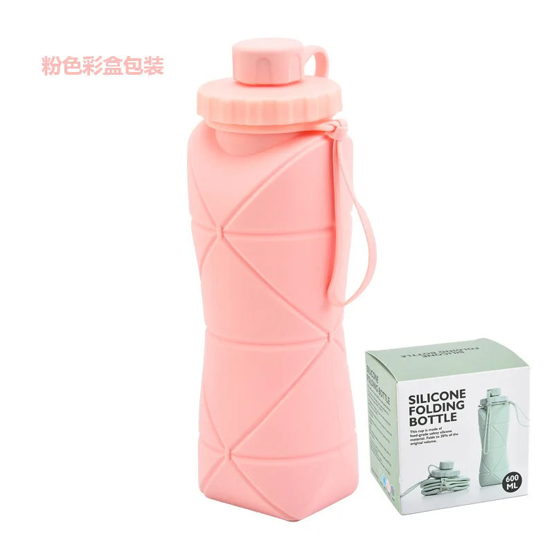 A pink silicone folding water bottle with a screw-on cap and a green box showing the product.