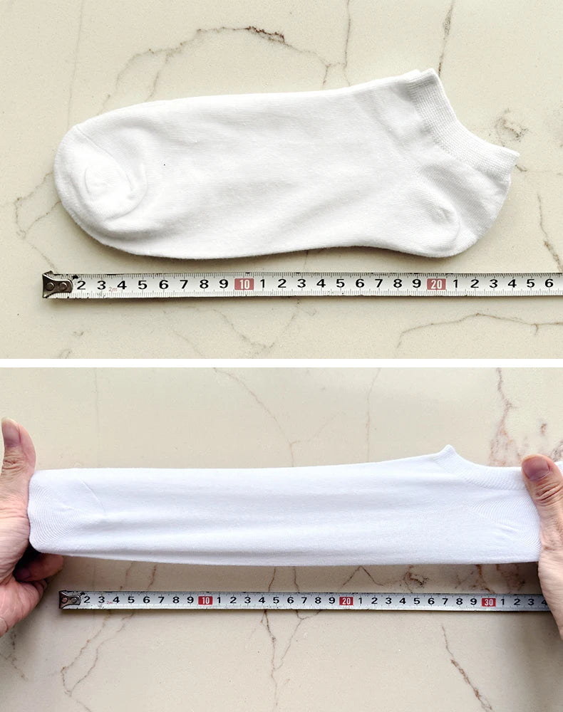 A white women's thin cotton no-show sock laid flat next to a ruler for size reference.
