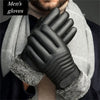 Black leather ski gloves worn by a man, featuring a gray scarf and fur trim.