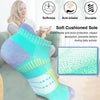 A pair of light blue and purple cushioned ankle socks is shown next to a woman, highlighting features like softness, anti-bli