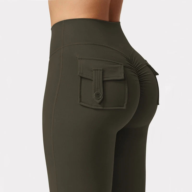 A close-up shot of a dark olive green high stretch women's yoga legging featuring a front pocket.