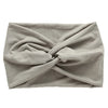 A gray women's elastic sports headband tied in a crisscross knot.