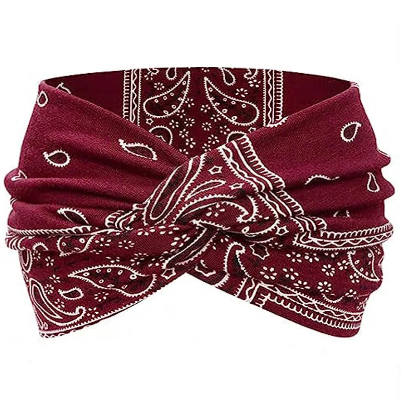 A burgundy fabric headband with white paisley and geometric patterns, suitable for yoga or bohemian style.