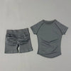 A light gray seamless yoga set for women featuring a short sleeve top and workout leggings.