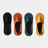 Four pairs of men's invisible boat socks in black, terracotta, dark green, and mustard yellow.