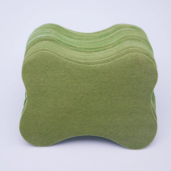 A stack of olive green self-heating lumbar spine patches.