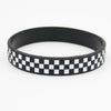 Black silicone wristband with a white checkered pattern.