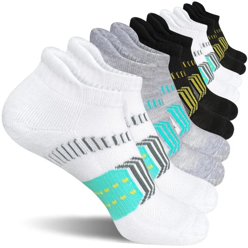 A stack of women's performance ankle socks in white, gray, and black with neon accents.