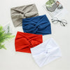 Collection de bandeaux de tête en tissu pliés gris, bleu, rouge et blanc, présentés sur une surface claire.
