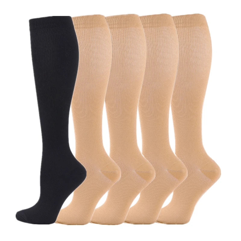 A row of five beige medical grade compression socks for veins and sports