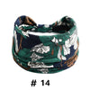Bandeau en coton stretch floral bleu foncé et vert style bohème porté autour de la tête.