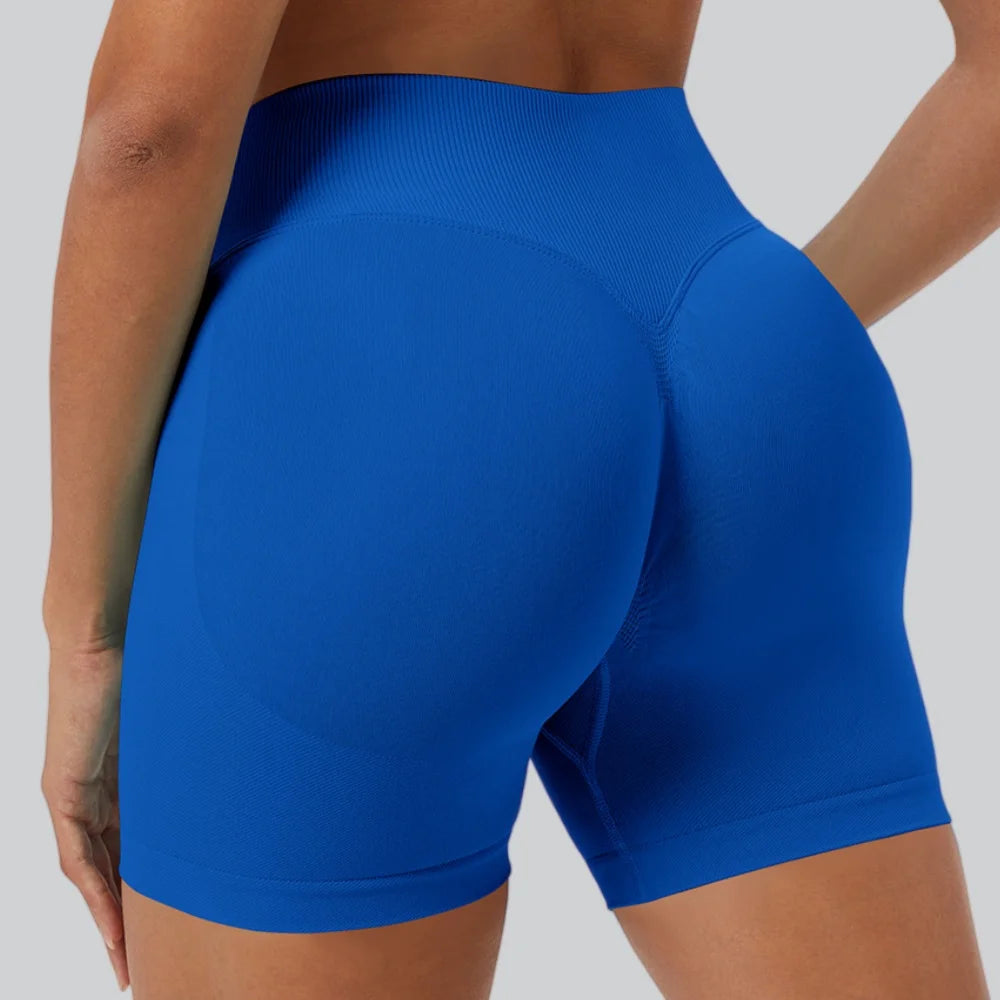 A close-up shot of a woman wearing royal blue seamless high-waist yoga leggings.