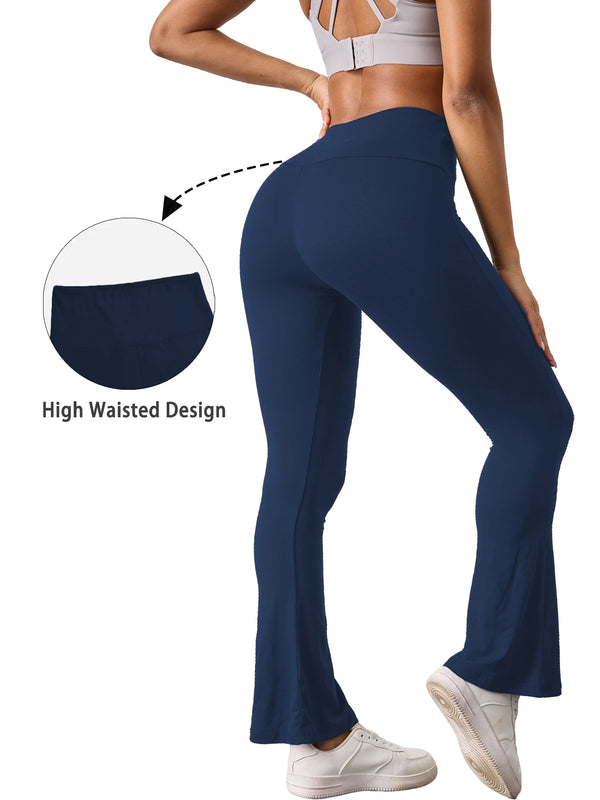 A woman wearing dark blue high-waisted yoga leggings with flare details, demonstrating the high waist design.