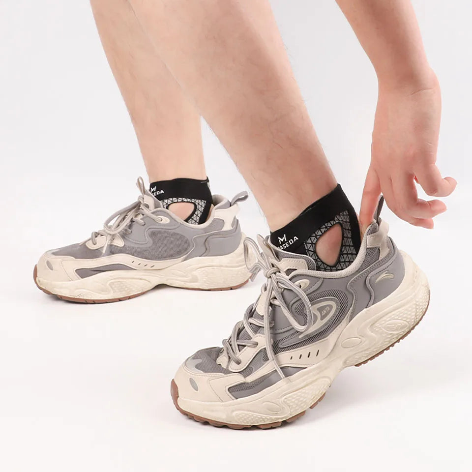 A person's foot wearing a gray and beige ultra-thin ankle brace for joint support.