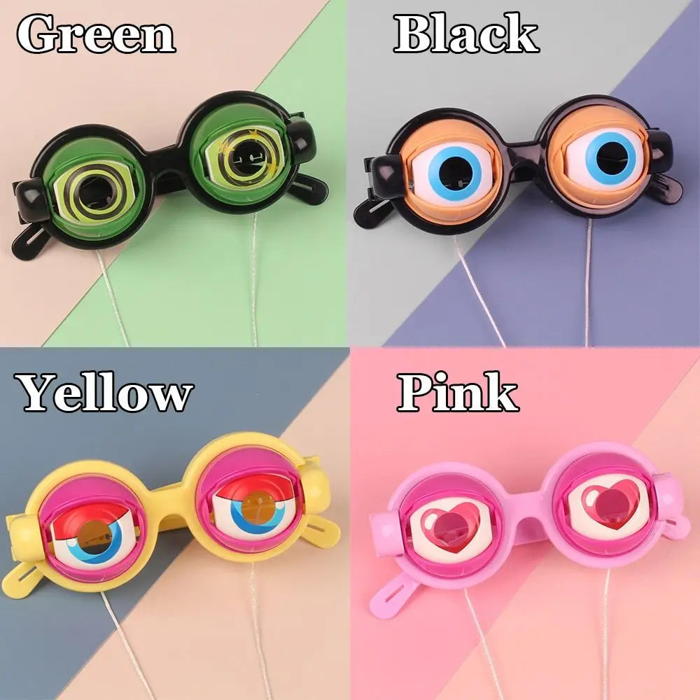 Four novelty glasses in green, black, yellow, and pink with various eye designs.