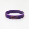 Purple silicone wristband with gold lettering displaying 77 Larry