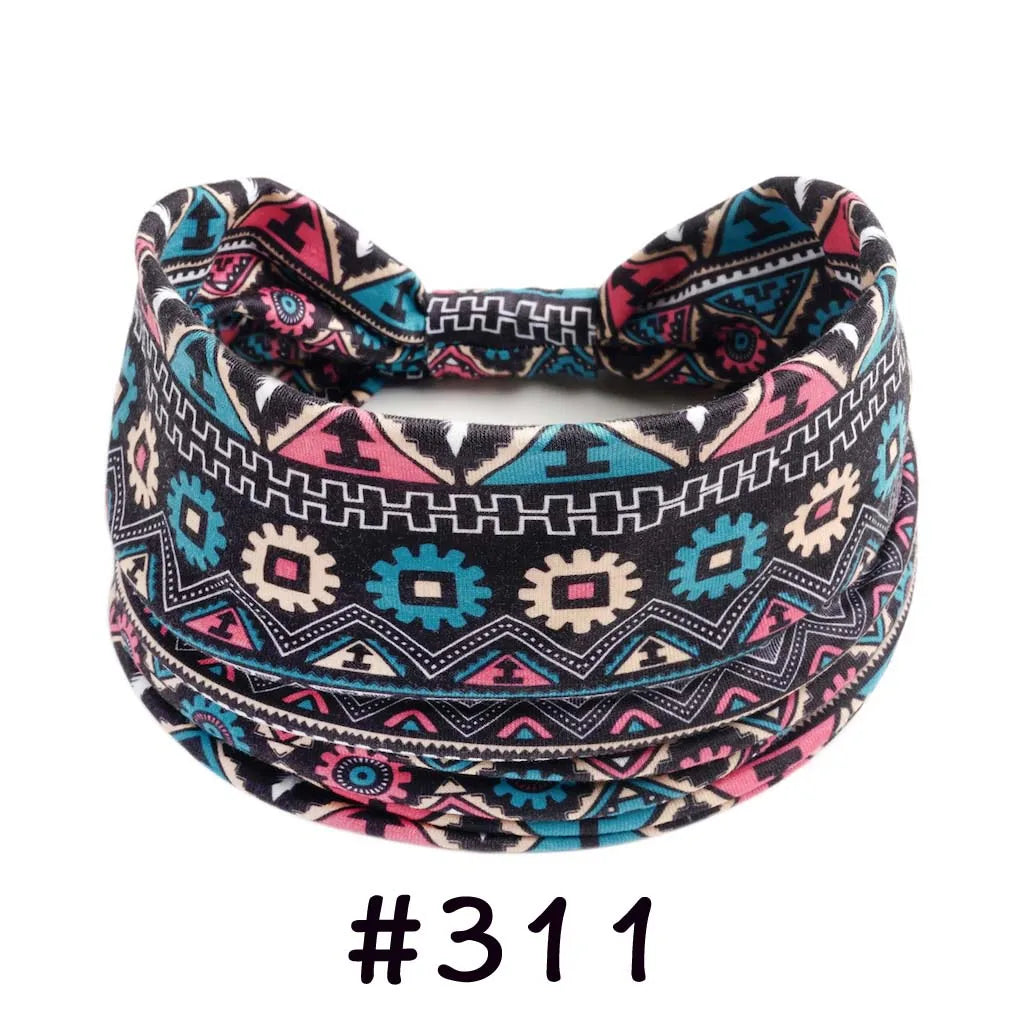 A patterned boho knotted cotton headband featuring geometric designs in black, pink, and teal.
