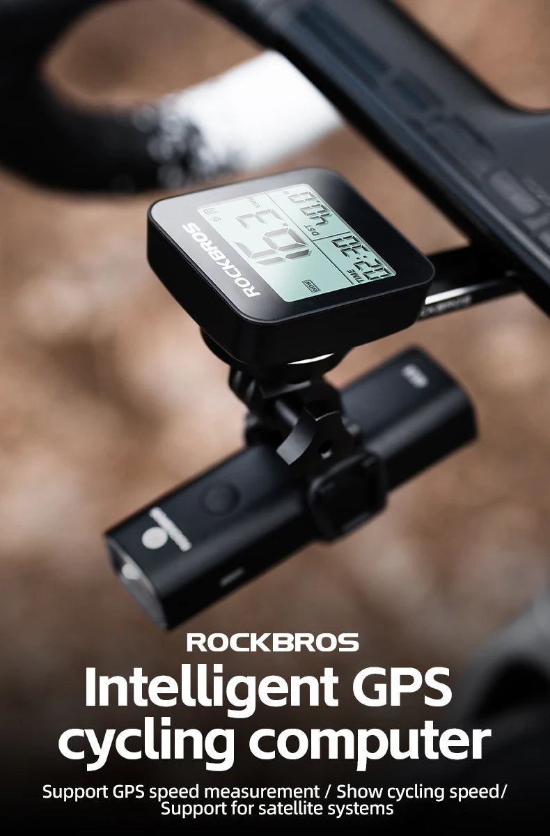 A black Rockbros intelligent GPS cycling computer mounted on a bicycle handlebar.