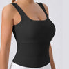 Black racerback padded tank top worn by a woman.