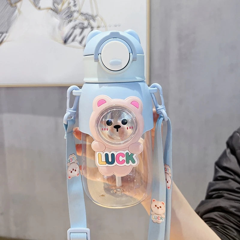 A light blue leak-proof water bottle shaped like a cute bear with the word LUCK on the front.