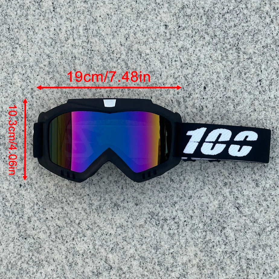 A pair of black heavy-duty motorcycle and ATV goggles with a strap, shown against a gray background.