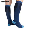 A pair of dark blue compression socks worn on a person's leg.