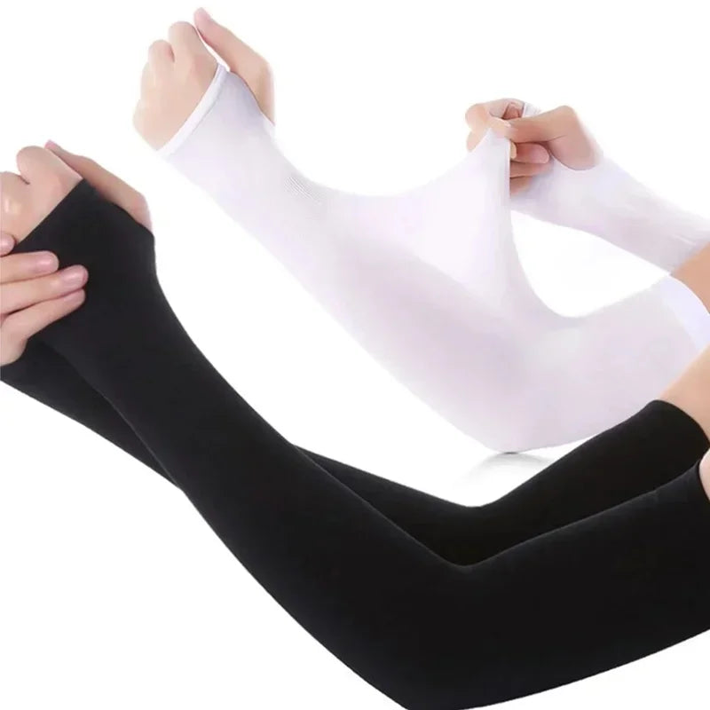 A pair of white and black ice sleeves for sports and outdoor activities being worn on a person's leg.