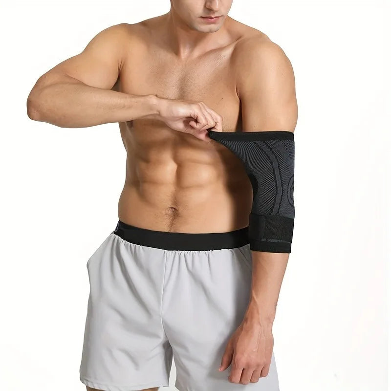 A man wearing a black joint support elbow protector sleeve on his right arm, standing against a white background.