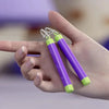 A hand holds a carrot-shaped fidget stress relief toy with white and lime green accents.