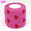 Pink elastic bandage tape rolled on, featuring a repeating red heart pattern.