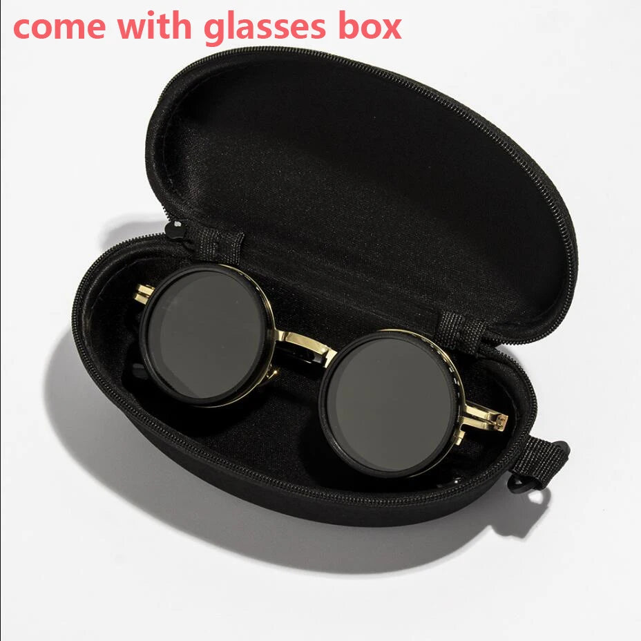A black velvet box containing a pair of round sunglasses with gold accents.