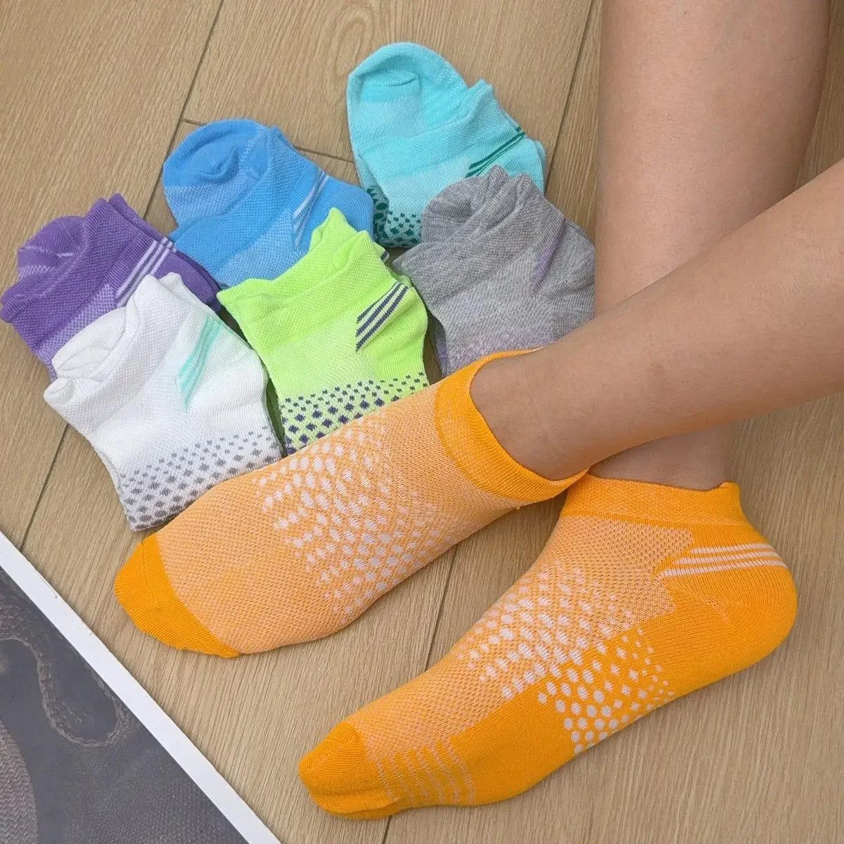 A collection of colorful breathable mesh ankle socks in various shades including blue, green, purple, and orange, displayed o