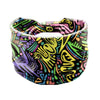 A colorful bohemian stretch cotton headband featuring abstract, swirling patterns in neon and dark colors.