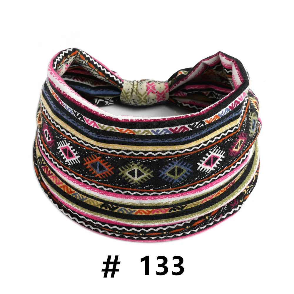 A colorful, patterned boho polka dot knotted headband worn around a head.