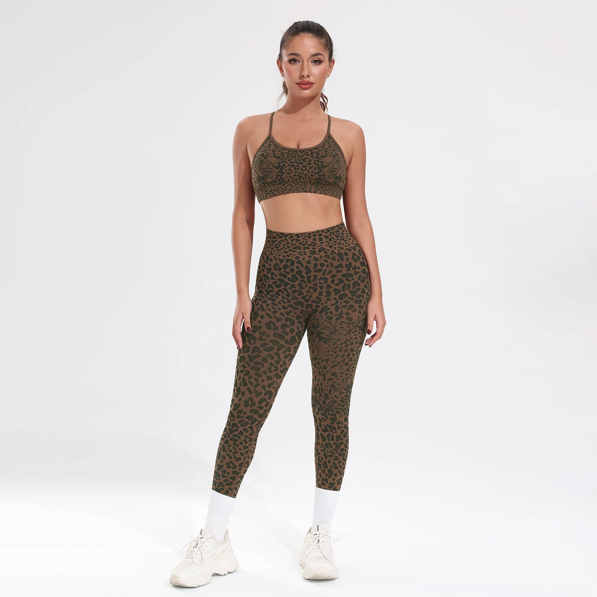 A woman models a leopard print seamless two-piece sports set consisting of a cropped top and leggings.