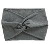 A gray women's elastic sports headband tied in an X shape.