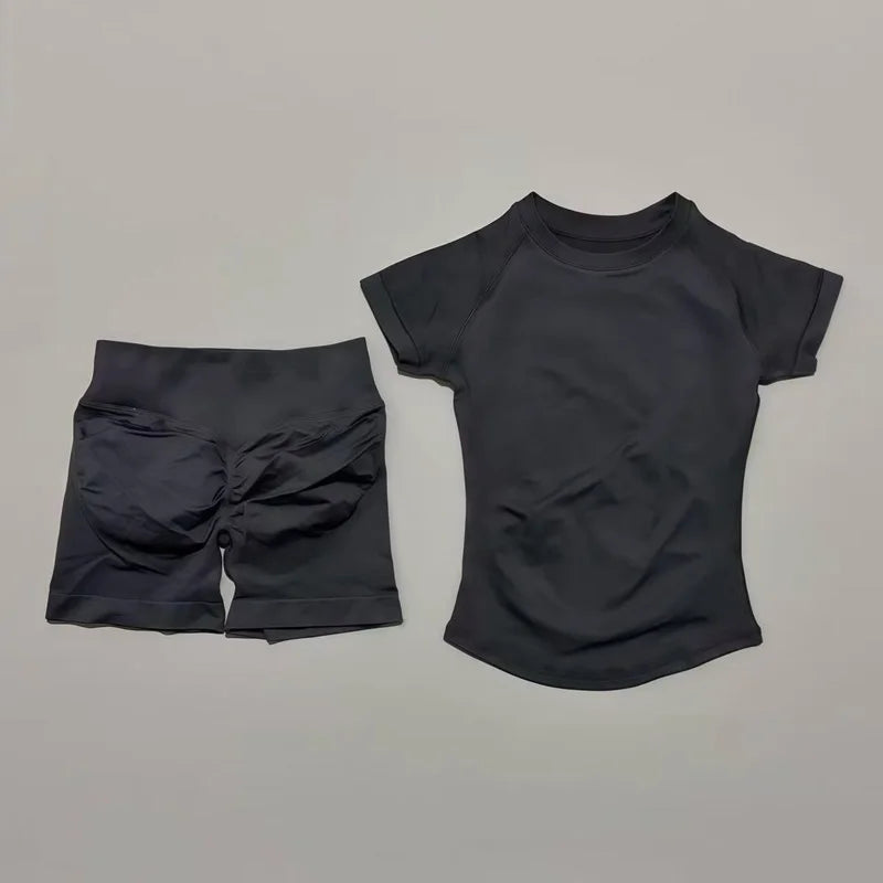 A black seamless yoga set for women featuring a short sleeve top and workout leggings.