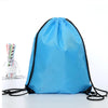 A light blue drawstring storage bag with black trim lying flat on a white surface.