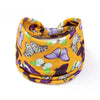 A yellow fabric headband featuring a pattern of purple and green butterflies.