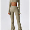 A woman models a beige women's performance tracksuit set consisting of a cropped top and matching full-length pants.