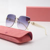Light luxury frameless sunglasses with gold accents resting on a pink box and a matching pink pouch.