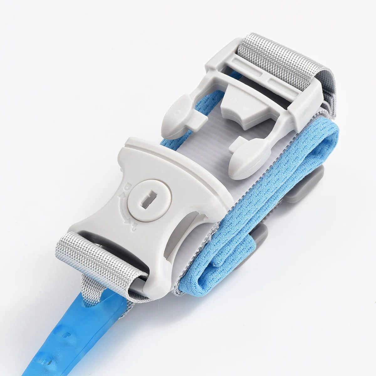 A white adjustable child safety harness and leash with blue fabric straps and gray plastic components.