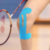 Blue kinesiology therapy tape applied to a knee for support during physical activity.